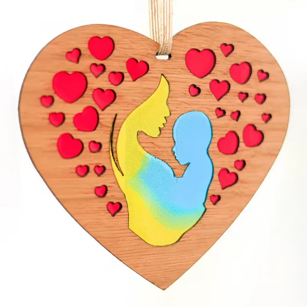Image showing a heart shaped laser cut decoration featuring mother and baby with hearts filled with colourful resins. Designed and handcrafted in Scotland by Kyloe Creations.