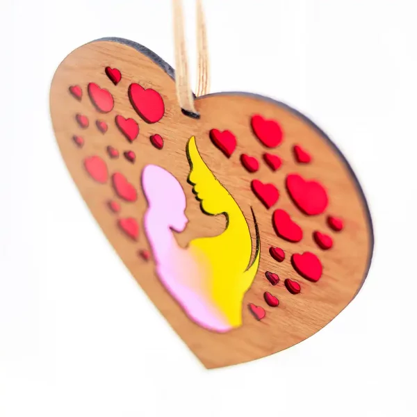 Image showing a heart shaped laser cut decoration featuring mother and baby with hearts filled with colourful resins. Designed and handcrafted in Scotland by Kyloe Creations.