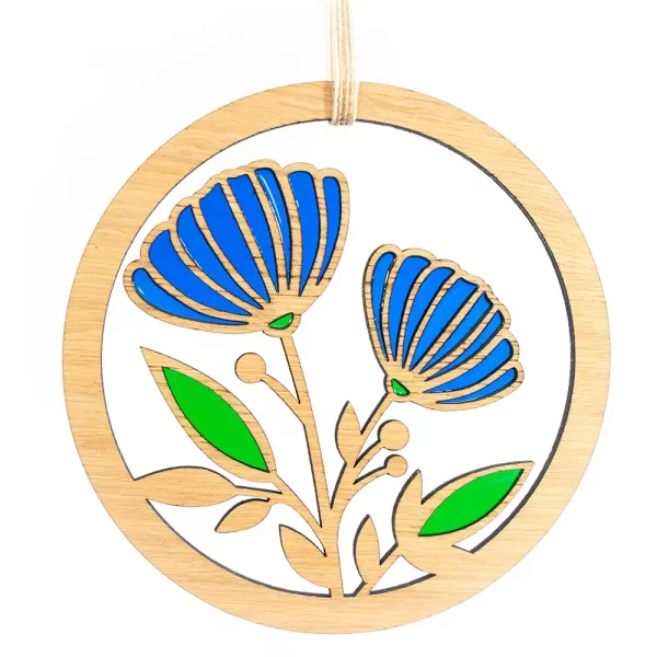 Image showing a circular wooden laser cut decoration featuring flowers and leaves filled with colourful resins. Designed and handcrafted in Scotland by Kyloe Creations.